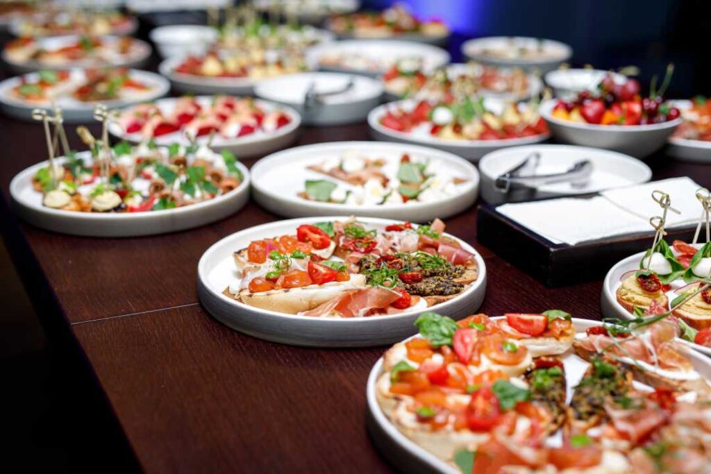 Trays of finger foods on a long table.
