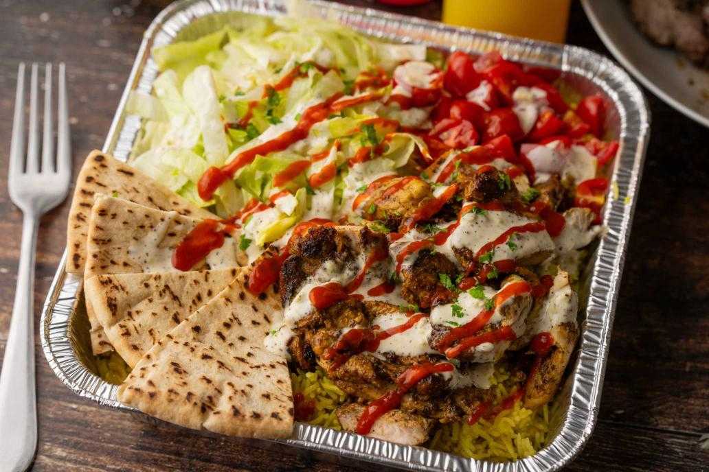 A close up of a foil dish of halal food.