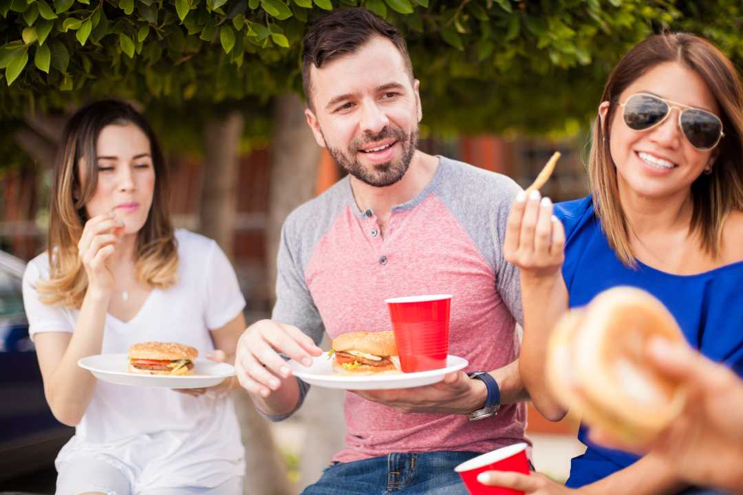 Employees enjoying a meal outdoors at pop-up events.