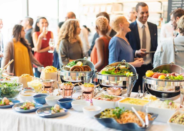 A large group of people enjoying dining & catering by Guardian Refresh.