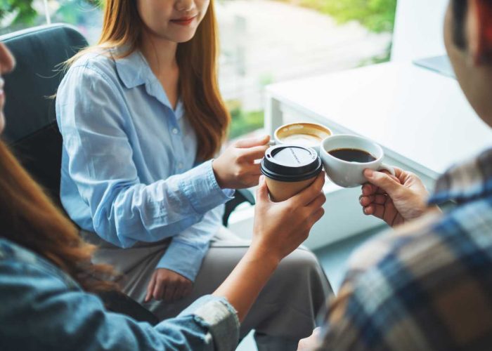 Employees enjoying office coffee service from Guardian Refresh.