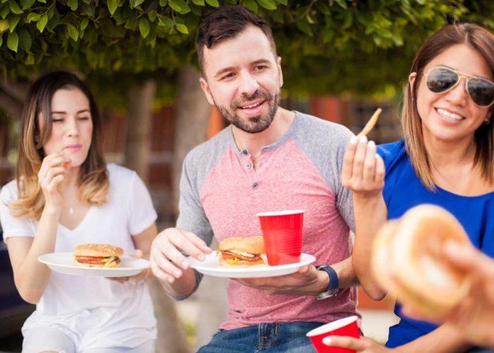 Employees enjoying a meal outdoors at pop-up events.